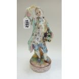 A German porcelain figure modelled as a dandy holding a basket of flowers,