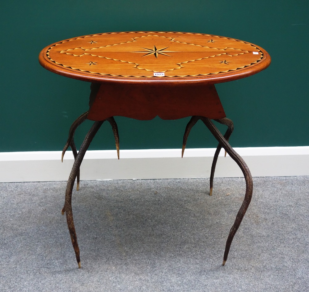 An Anglo-Indian inlaid oval occasional table, on a pair of antler supports, 75cm wide.