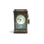 A brass and champlevé decorated carriage clock, circa 1900, with inset bevelled panels,