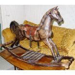 A 20th century carved wooden rocking horse.