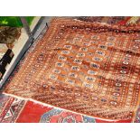 A brown Indian Bokhara rug, 184cm x 127cm, and a Caucasian rug, 190cm x 136cm, (2).