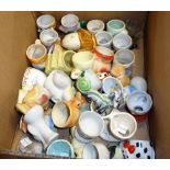 A large quantity of 20th century novelty egg cups, (qty).