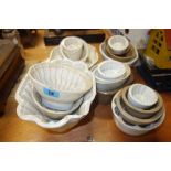 A group of early 19th century and later pottery jelly moulds of assorted patterns and designs,