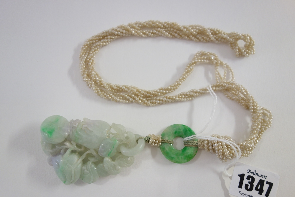 A Chinese jadeite pendant, 20th century, carved as branches of peaches and finger citron,
