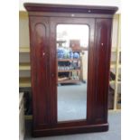 A Victorian mahogany wardrobe with single mirrored door,