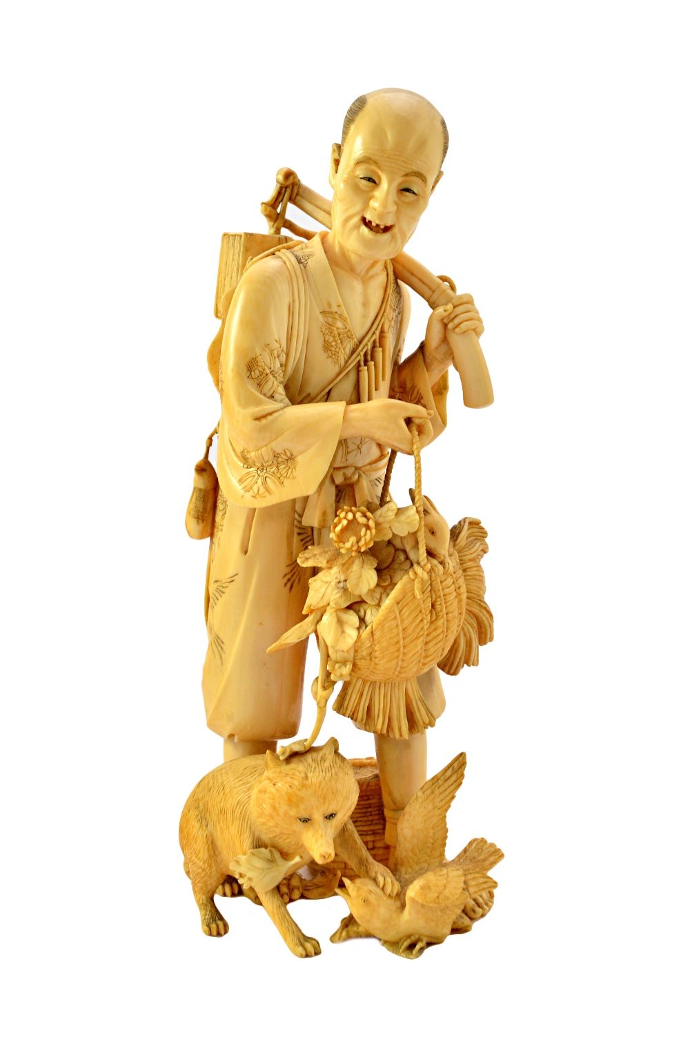 A Japanese ivory okimono of a tradesman, Meiji period,