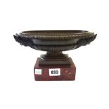 After the Antique; a bronze oval urn of shallow form, 19th century,