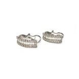 A pair of white gold and diamond set earclips,