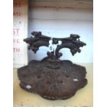 A Victorian cast iron boot scraper with a foliate pierced base, 37cm wide,