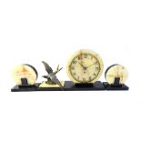 An Art Deco onyx and black slate mantel clock garniture,