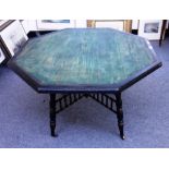Howard & Sons; a 19th century parcel gilt ebonised octagonal centre table, on turned supports,