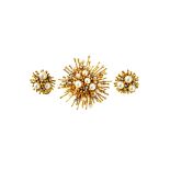 A gold, diamond and cultured pearl set brooch, designed as a starburst,