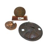 A bronze 'Christopher Award', dated 1958, on a wooden stand, 10cm diameter,