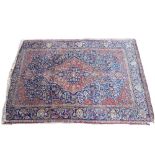 An Isfahan rug, Persian, the indigo field with a madder medallion and spandrels,