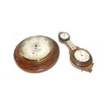 A circular walnut carved wall barometer compendium by 'Jas Pithial London' with subsidiary