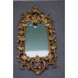 An 18th century style gilt framed wall mirror with opposing 'C' scroll upper and lower frieze and