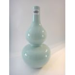 A Chinese porcelain vase of double gourd form, covered in a a light greenish blue glaze,