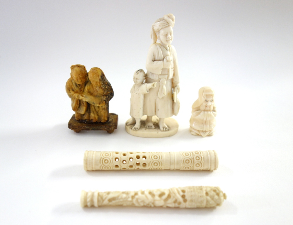 A small Indian ivory carving of a man and child, late 19th/early 20th century,