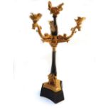 A pair of gilt and patinated bronze four branch candelabra, each of Empire style,