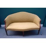 A George III mahogany framed tub back sofa with serpentine seat on tapering square supports,