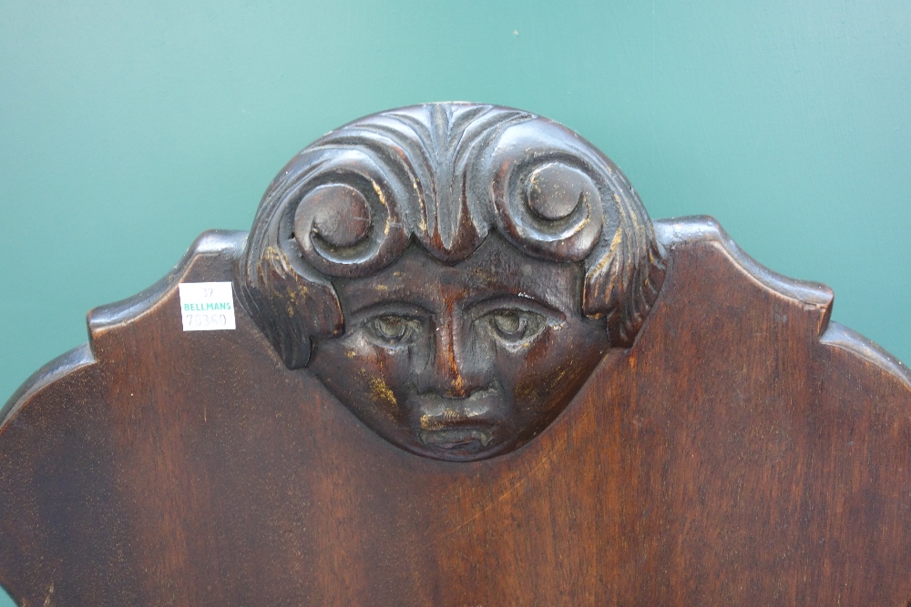 A pair of 19th century mahogany hall chairs, the shaped backs with carved face masks, - Image 2 of 3