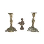 A pair of Rococo style gilt bronze candlesticks, 19th century, raised on three foliate scroll feet,
