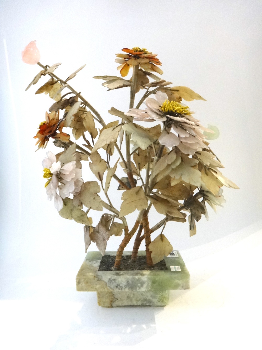 A Chinese hardstone model of a flowering tree, circa 1900, in a stepped rectangular jardinière,