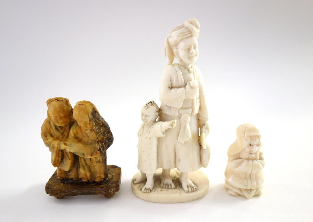 A small Indian ivory carving of a man and child, late 19th/early 20th century, - Image 2 of 9