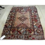 An Indian part silk rug, the field with stylised diamond design, complementary section border,