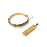 A 9ct gold rectangular ingot pendant and a 9ct gold oval hinged bangle, decorated with bamboo,