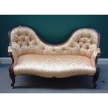 A Victorian rosewood framed double spoon back sofa, with serpentine seat on cabriole supports,