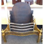 An 18th century style steel and brass fire basket, with pierced serpentine front and urn finials,