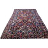 A Bakhtiari carpet, Persian, the trellis field filled with flowers, trees and birds,