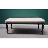 A mahogany framed rectangular footstool, with serpentine short ends on carved and turned supports,