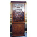 A George III mahogany bookcase cabinet, the single astragal glazed door over panelled cupboard,