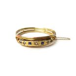 A sapphire and diamond set oval hinged bangle,