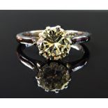 A platinum and white gold diamond set single stone ring, claw set with a circular cut diamond,