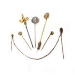 A Victorian gold stick pin, glazed with an oval hair locket compartment at the centre,