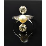 A white gold and platinum ring, mounted with a cultured pearl at the centre,