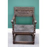 A Charles II brass studded leather upholstered oak framed square back open armchair with bobbin