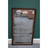 A George II parcel gilt walnut framed rectangular wall mirror, with rounded arch top,