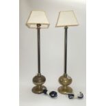 A pair of Victorian bronze table lamps, each with a plain iron stem and bulbous turned base,