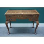 An 18th century style figured walnut writing desk, with four frieze drawers, on cabriole supports,