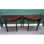 A pair of George III mahogany ebony strung 'D' shaped consoles, on tapering square supports,