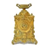 A French gilt bronze mantel clock, 19th century, with urn surmount, lion and Bacchus masks,