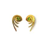 A pair of 18ct gold and peridot set single stone earclips, each in a swirling design,