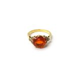 A gold, fire opal and diamond set ring, claw set with the circular cut fire opal at the centre,