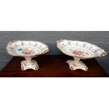 A pair of Royal Crown Derby fruit comports painted with floral bouquets, 27.