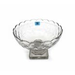 An early 19th century Irish facet cut glass fruit bowl, on a stepped pillar and square plinth base,