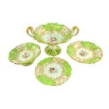 A Rockingham style porcelain dessert service, first half 19th century, centred by floral bouquets,